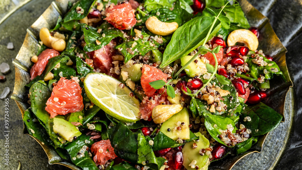 Food recipe background. Close up Avocado, quinoa, spinach, grapefruit, pomegranate, nuts and microgreens salad