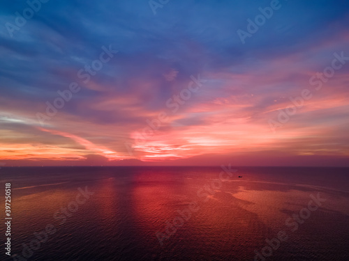 Beautiful red sunset over the ocean. © Kridsadar
