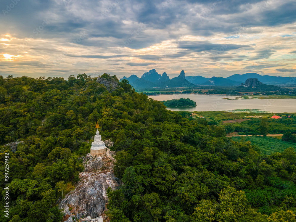 Mueang Lop Buri District, Lopburi / Thailand / October 11,2020   : Wat Pa Phatthara Piyaram. Temple with cave carvings.  Aerial View of Buddha Temple Pagoda with Mountain and Blue sky