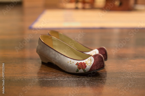 Korean traditional flower shoes wedding images on floor.