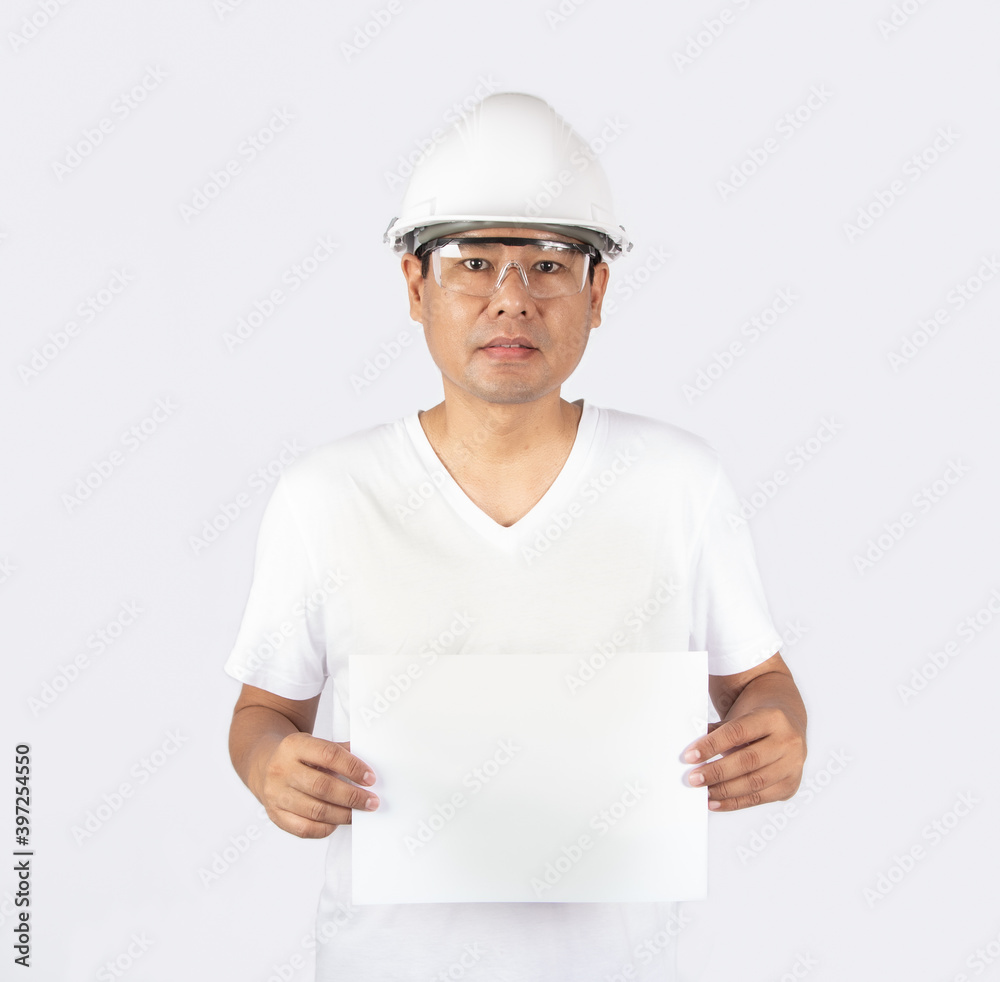 Portrait of a Asian male worker in protection glasses and helmet with copy space. Technician man holding an empty paper on white background Portrait of a Asian male worker in protection glasses and helmet with copy space. Technician man holding an empty paper on white background