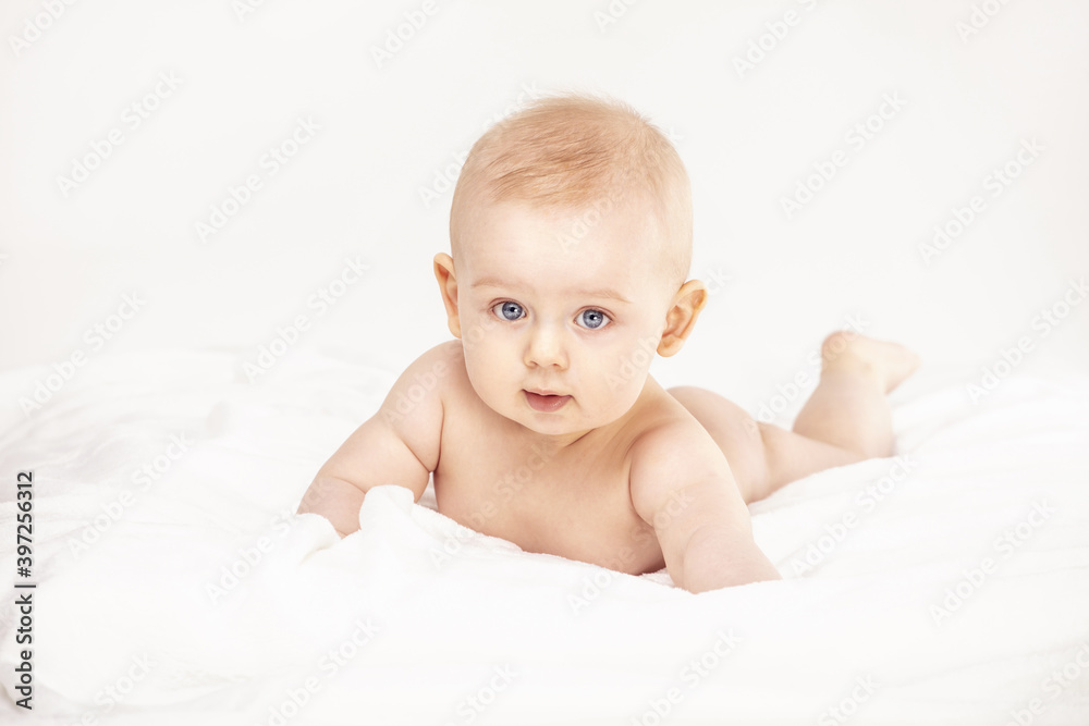 Cute baby boy smiling to the camera, lying on white background. Cute baby boy smiling to the camera, lying on white background.