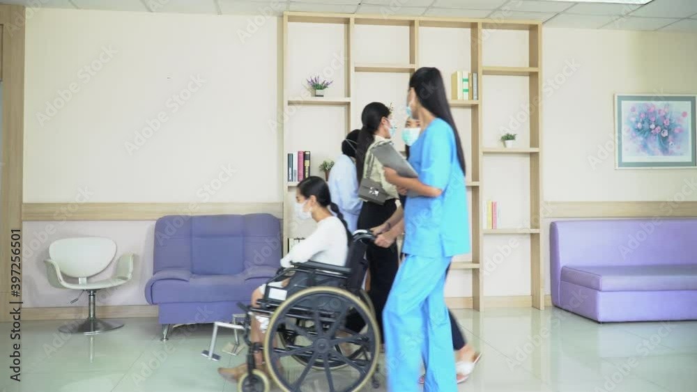 group of asian doctor and patient wearing medical mask and face shield working and walking through hospital hallway protect coronavirus outbreak or Covid-19 pandemic group of asian doctor and patient wearing medical mask and face shield working and walking through hospital hallway protect coronavirus outbreak or Covid-19 pandemic