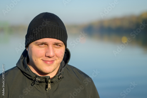 Happy friendly young man in a beanie hat © michaelheim