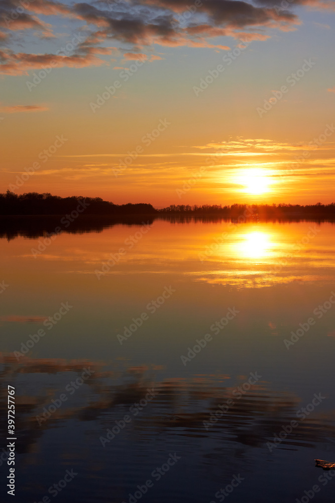 Beautiful landscape showing sunset over river on clear autumn day