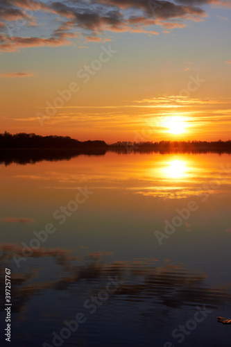Beautiful landscape showing sunset over river on clear autumn day © watcherfox