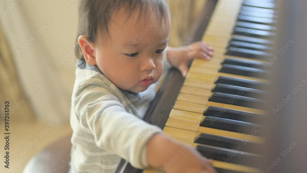 Cute little baby boy plays piano at home Cute little baby boy plays piano at home