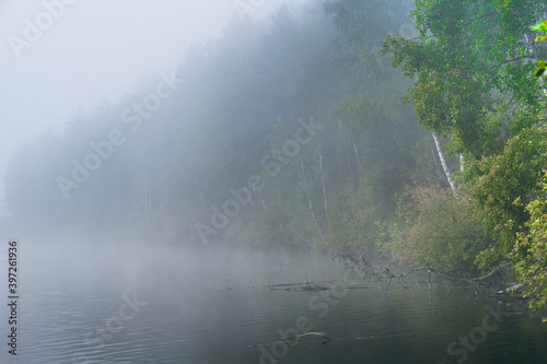 Fog over the surface of water on lake. Morning haze on river