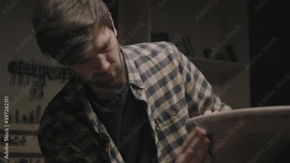 Handcrafted: carpenter makes furniture, table, polishes wood