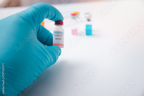 Researcher holding vaccine sample in the laboratory. Researcher is inventing vaccines to treat COVID-19 virus.