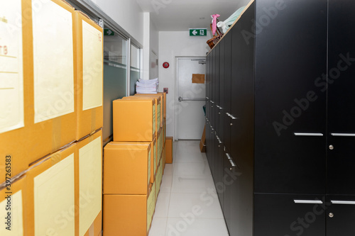 Cardboard box with products and file cabinet in the warehouse.