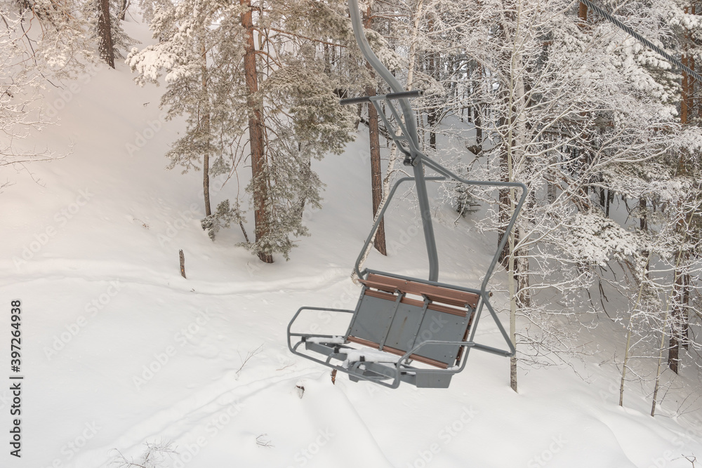 Chair lift in snowy winter landscap. Chairlift over frost forest Chair lift in snowy winter landscap. Chairlift over frost forest