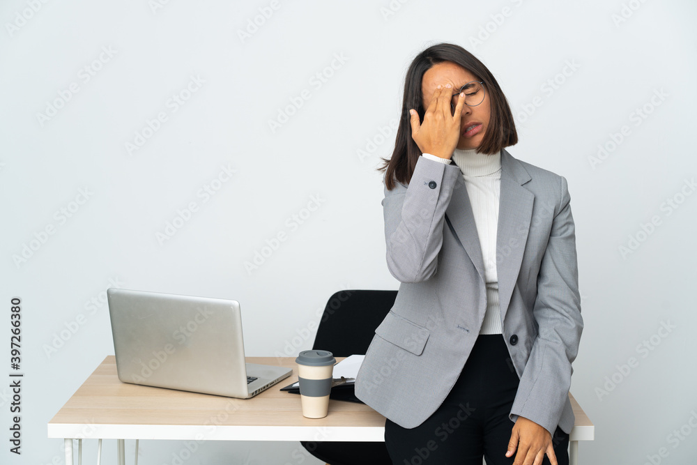 Young latin business woman working in a office isolated on white background with headache Young latin business woman working in a office isolated on white background with headache