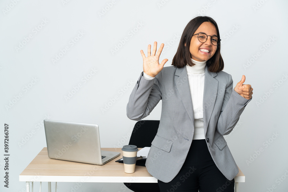 Young latin business woman working in a office isolated on white background counting six with fingers Young latin business woman working in a office isolated on white background counting six with fingers