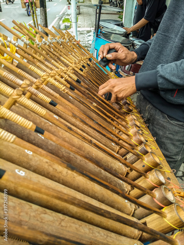 street artist playing angklung in traffic light photo