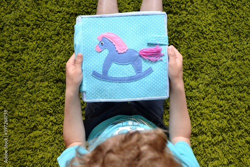 child playing with toy quietbook