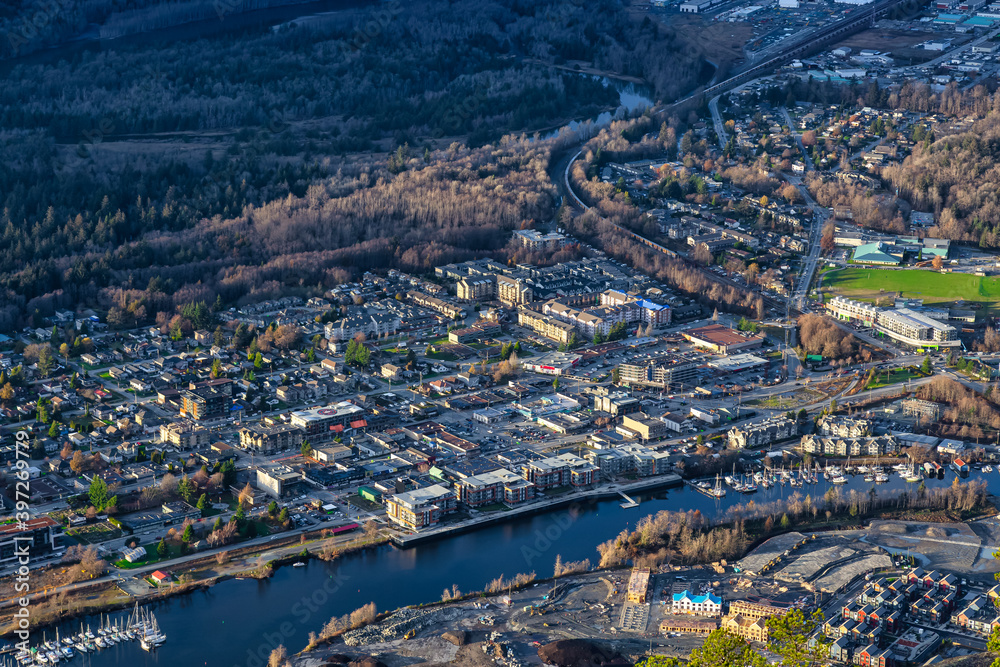 Aerial View of Squamish City during a sunny sunset. Taken from Chief Mountain, near Vancouver, British Columbia, Canada.