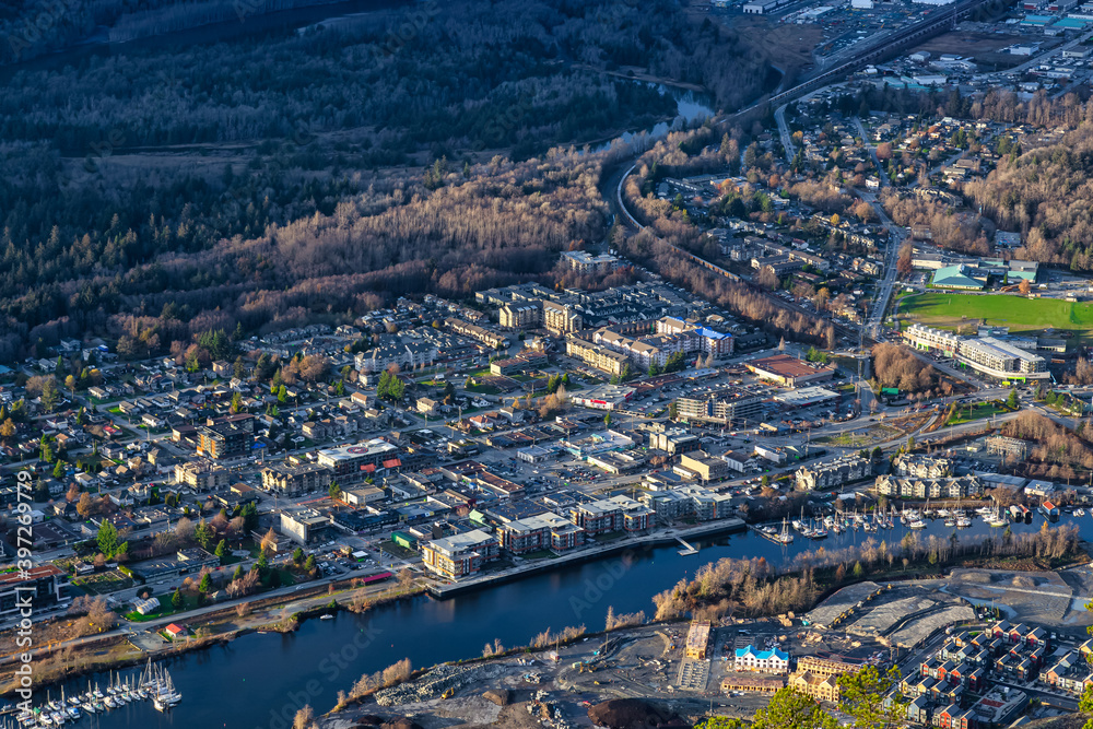 Aerial View of Squamish City during a sunny sunset. Taken from Chief Mountain, near Vancouver, British Columbia, Canada. Aerial View of Squamish City during a sunny sunset. Taken from Chief Mountain, near Vancouver, British Columbia, Canada.