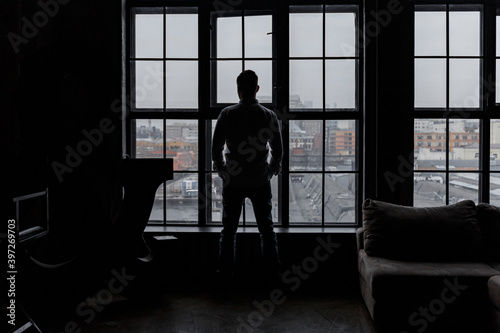 Man looking out the window. Businessman. Industrial. From window