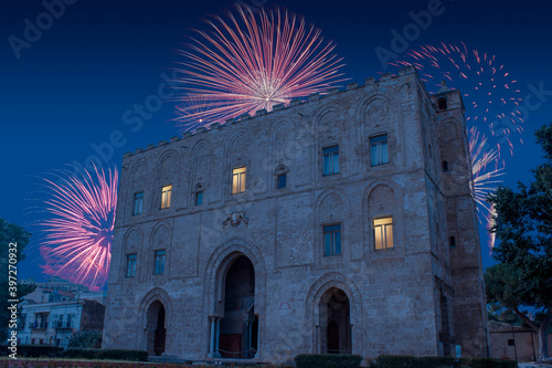 Celebratory fireworks for new year over La Zisa in Palermo Sicily, shot of one of the best preserved Norman castles in Italy during last night of year. Christmas blue atmosphere 