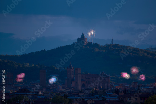 Celebratory fireworks for new year over San Luca Basilica or cathedral or church during last night of year. Christmas atmosphere. it is seen the asinelli tower and Saint Petronio, Bologna -Italy