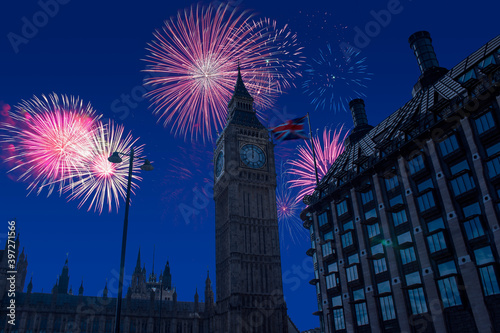 Celebratory fireworks for new year over big ben tower or clock in London, united kingdom ( UK ) during last night of year. Christmas atmosphere