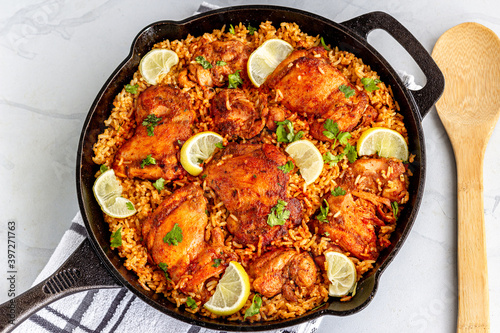 One Pan Spanish Chicken and Rice in a Skillet with Serving Spoon