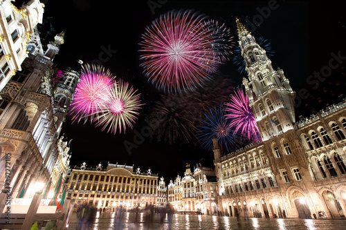 Celebratory fireworks for new year over grand place or square in Brussels, Belgium during last night of year. Christmas atmosphere. 