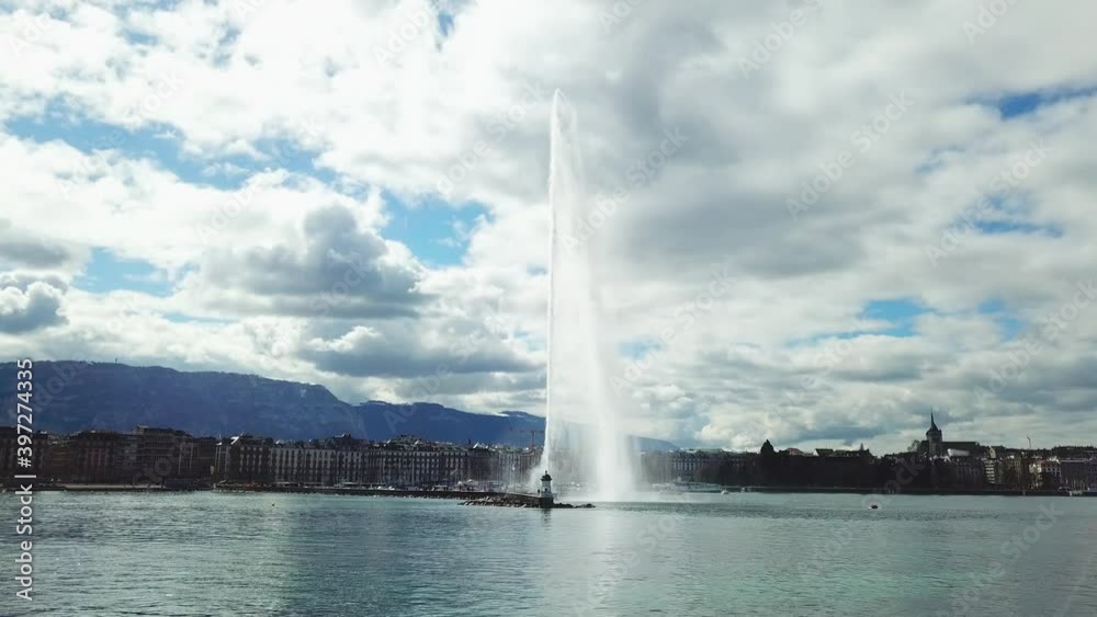 Aerial view of Geneva and aerial view of water jet fountain. Drone flying over the picturesque cityscape Aerial view of Geneva and aerial view of water jet fountain. Drone flying over the picturesque cityscape