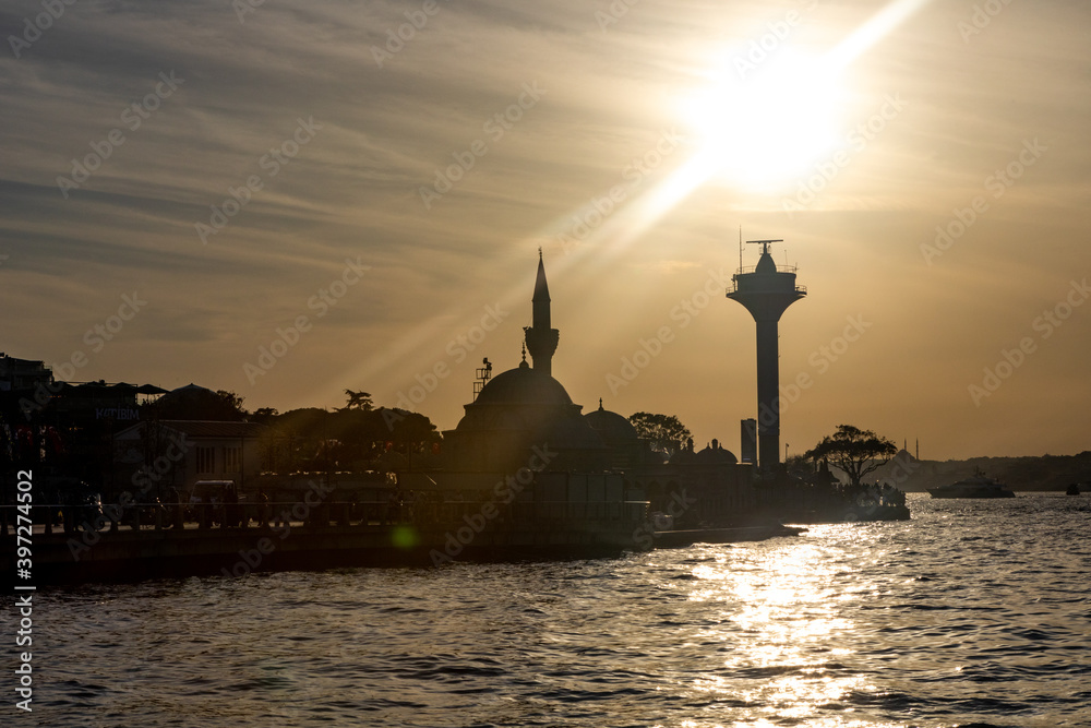 Istanbul, Turkey - September 2020: Uskudar promenade and beach meeting sunset with view of Maiden's tower