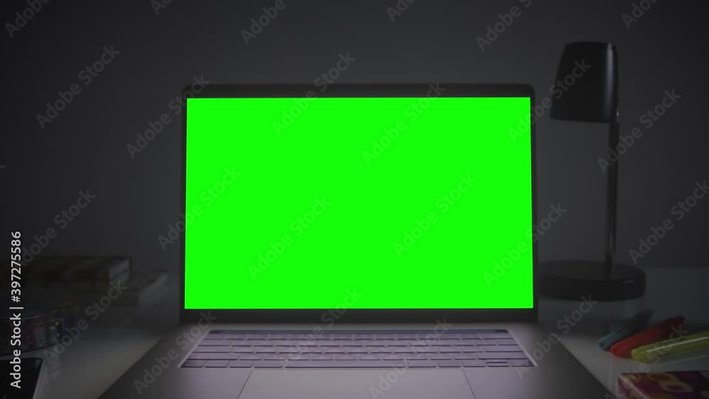 Home office setup with chroma key. Dolly out of laptop with green screen on a white desk. Perfect to put your own images or videos. Track corners with perspective corner pin. Home office setup with chroma key. Dolly out of laptop with green screen on a white desk. Perfect to put your own images or videos. Track corners with perspective corner pin.