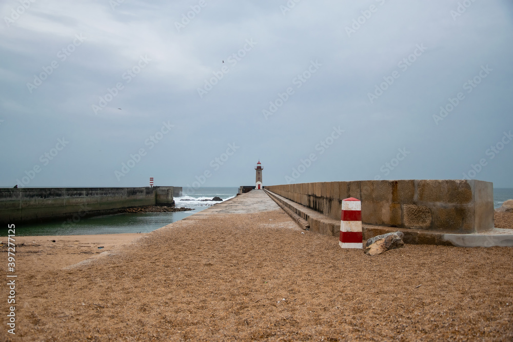 Coastline of Atlantic ocean. Rainy day and waves. Historical Felgueiras Lighthouse built on 1886 in Foz do Douro near from Porto, Portugal Coastline of Atlantic ocean. Rainy day and waves. Historical Felgueiras Lighthouse built on 1886 in Foz do Douro near from Porto, Portugal