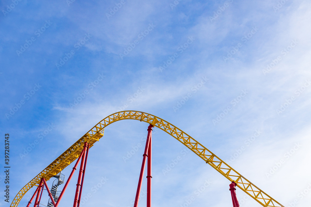 summer blurred photo of Rollercoaster against blue sky summer blurred photo of Rollercoaster against blue sky