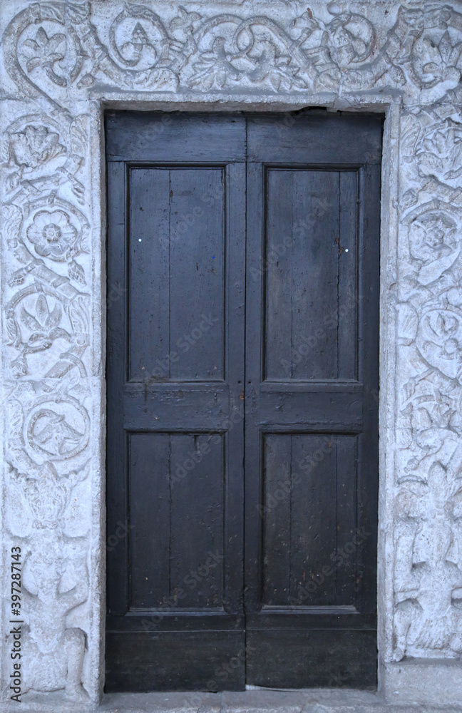 Old door of a palace in the city of Narni, Italy