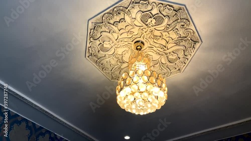 Moroccan stylish lamp hanging in the ceiling of an apartment 