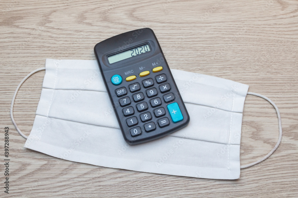 Fabric mask and calculator with 2020 on the screen Fabric mask and calculator with 2020 on the screen