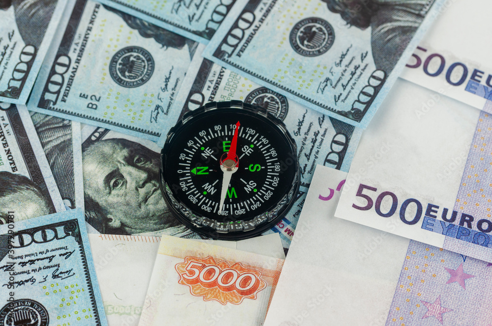 dollars euros and rubles and compass, the concept of currency fluctuations dollars euros and rubles and compass, the concept of currency fluctuations
