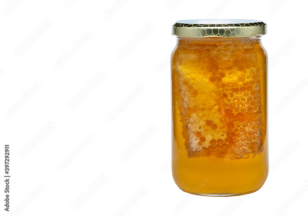 glass jar with honey and pieces of wax glass jar with honey and pieces of wax