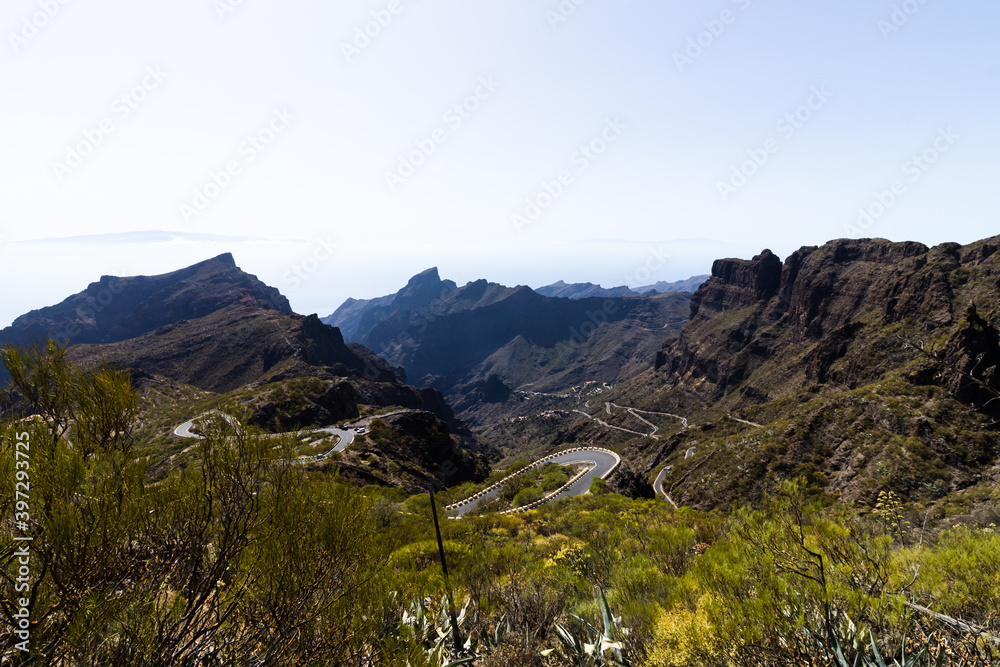 Green mountain hills and winding road near Masca village on a sunny day, Tenerife
