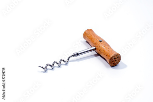 Corkscrew wine bottle opener with wooden handle isolated on white background. Close up  photo
