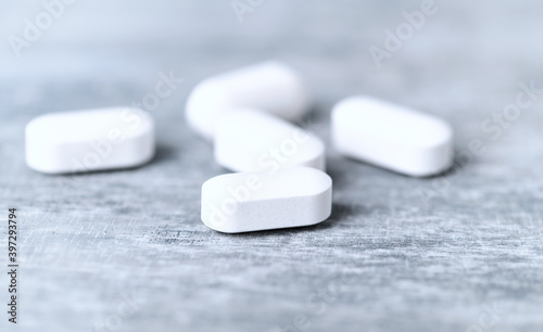 L - Carnitine tablets. Concept for a healthy dietary supplementation. Wooden background. Close up. 