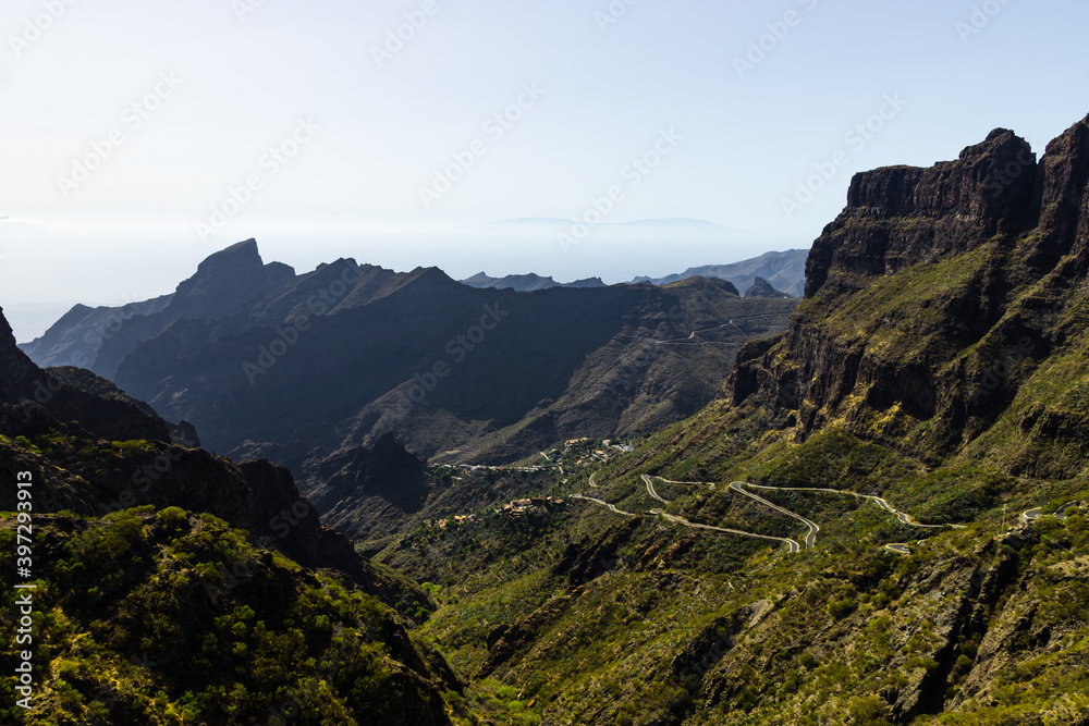 Green mountain hills and winding road near Masca village on a sunny day, Tenerife