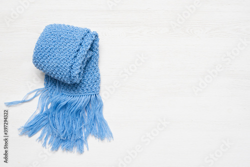 Blue scarf on the white wooden table background.