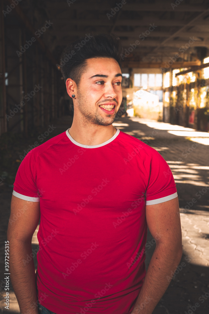 Young caucasian man posing in a abandoned pavilion. Young caucasian man posing in a abandoned pavilion.