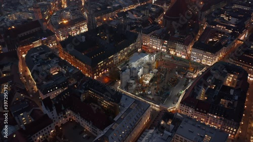 Wallpaper Mural Huge Construction Building Site in Urban environment City Center of Munich, Germany at Night with lighting equipment and big machinery, Aerial dolly out tilt up Torontodigital.ca