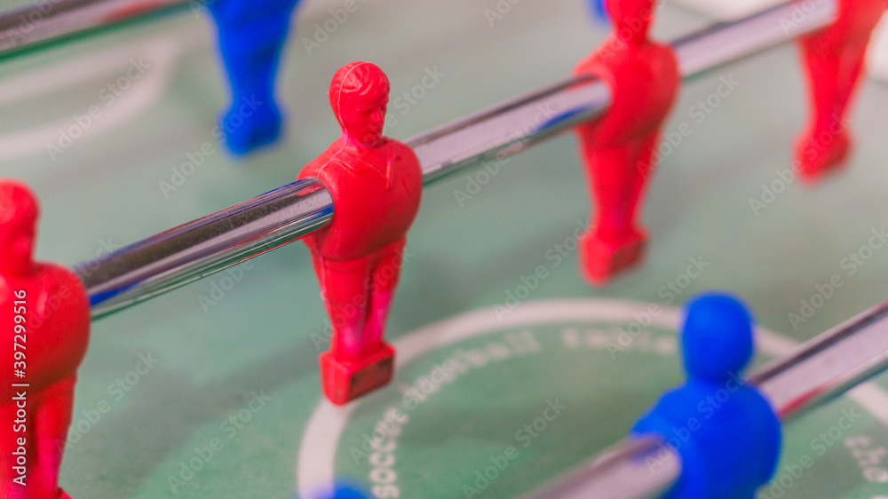 Red and blue table football player on steel rod isolated, GREEN BACKGROUND Red and blue table football player on steel rod isolated, GREEN BACKGROUND