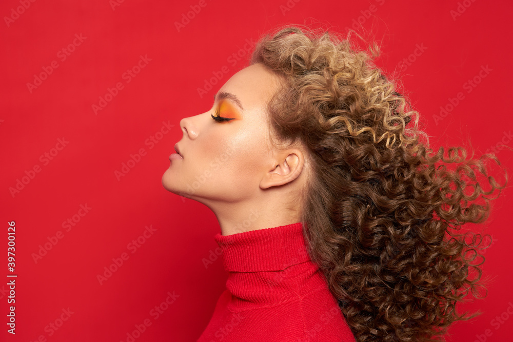 beautiful young girl in a red jacket on a red background with a new year mood beautiful young girl in a red jacket on a red background with a new year mood