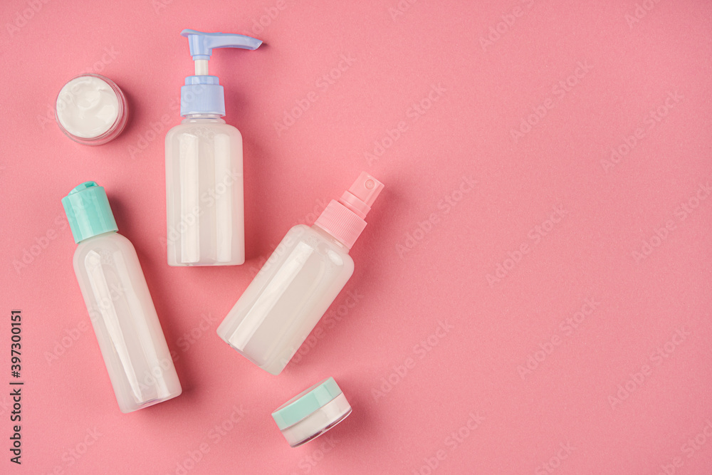 Packaging of cream, lotion, gel, facial foam or skin care. Soap and cream bottles on pink background. Cosmetic beauty product branding mock-up. Copy space Packaging of cream, lotion, gel, facial foam or skin care. Soap and cream bottles on pink background. Cosmetic beauty product branding mock-up. Copy space