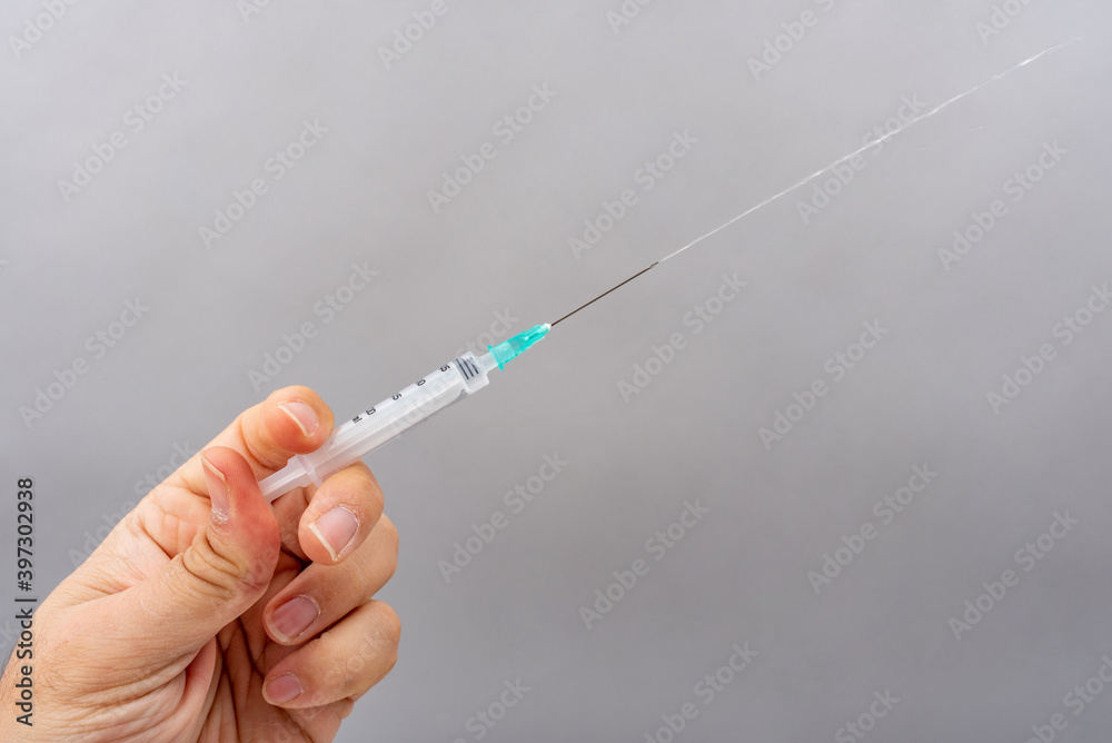 medicine flowing from the syringe medicine flowing from the syringe