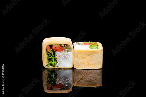 square shaped sushi wrapped in pita bread. on black background
